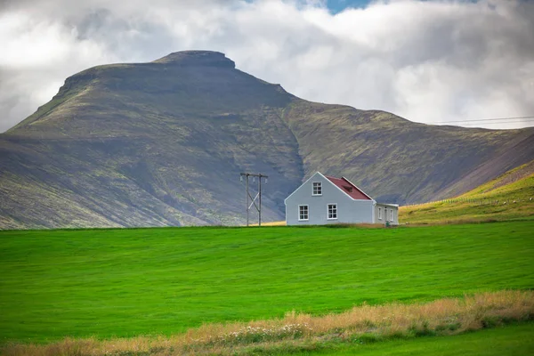 Горный пейзаж с исландским домом — стоковое фото