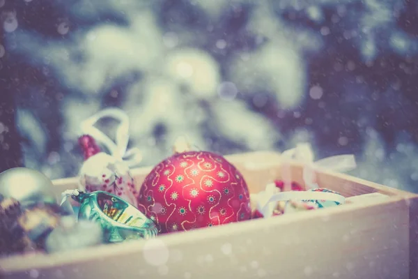 Christmas decoration balls in a wooden box — Stock Photo, Image