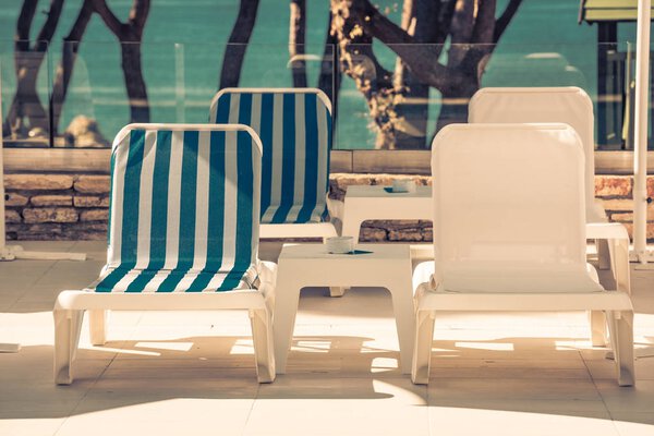 sunbeds and umbrellas by the swimming pool on a sunny day