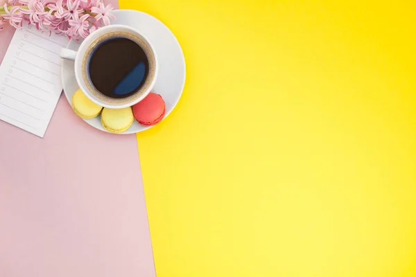 Flat lay of coffee cup with macaroons