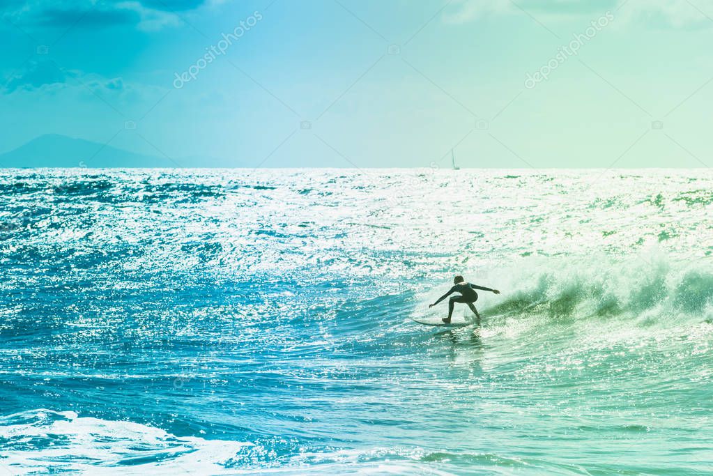 Surfers riding some waves on the sea