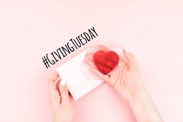 Giving Tuesday concept with red heart in hand