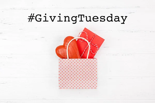 Giving Tuesday concept with heart and gift in bag