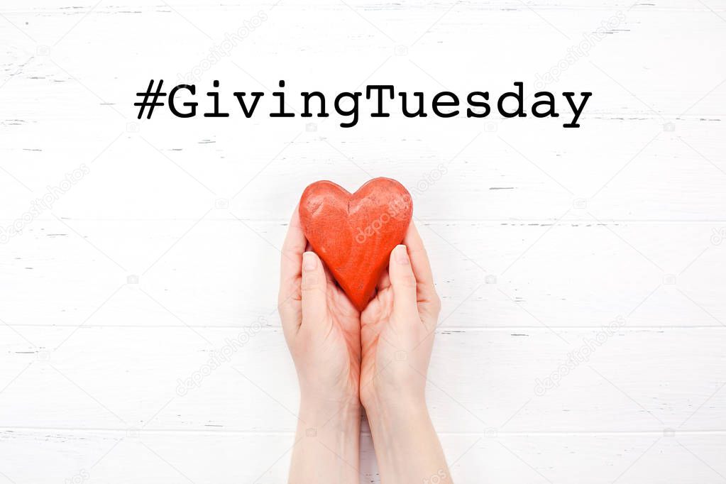 Giving Tuesday concept with red heart in hands