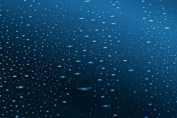 Water drops on classic blue gradient background — Stok fotoğraf