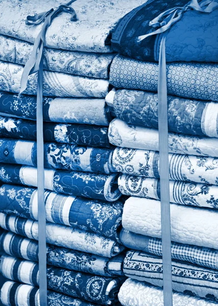 Handmade blankets pile blue toned — Stock Photo, Image