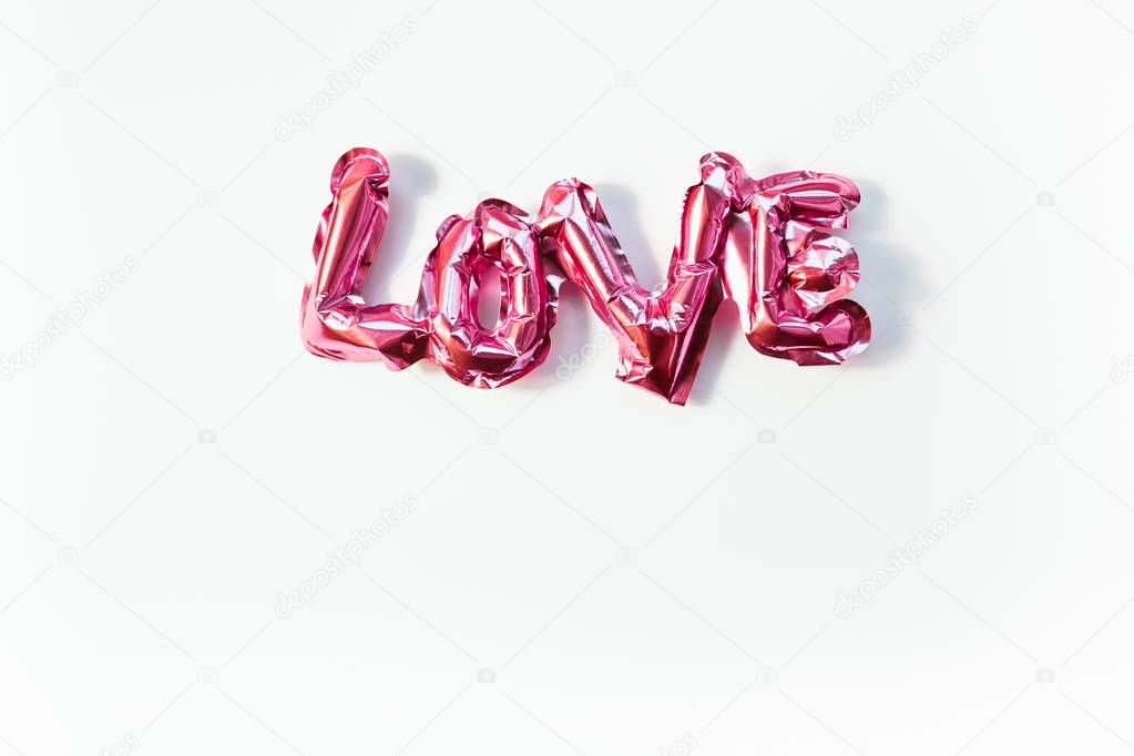 Love concept. Inflatable pink balloon with letters