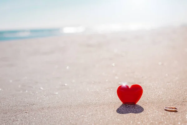 Romantic symbol of red heart on the sand beach — Stock Photo, Image