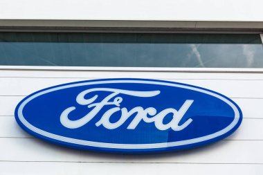 Ford Motor Şirketi 'nin Lyon, Fransa' daki araba satıcısı ofis binasında bulunan parlak mavi gökyüzü arka planının logosu - 23 Şubat 2020