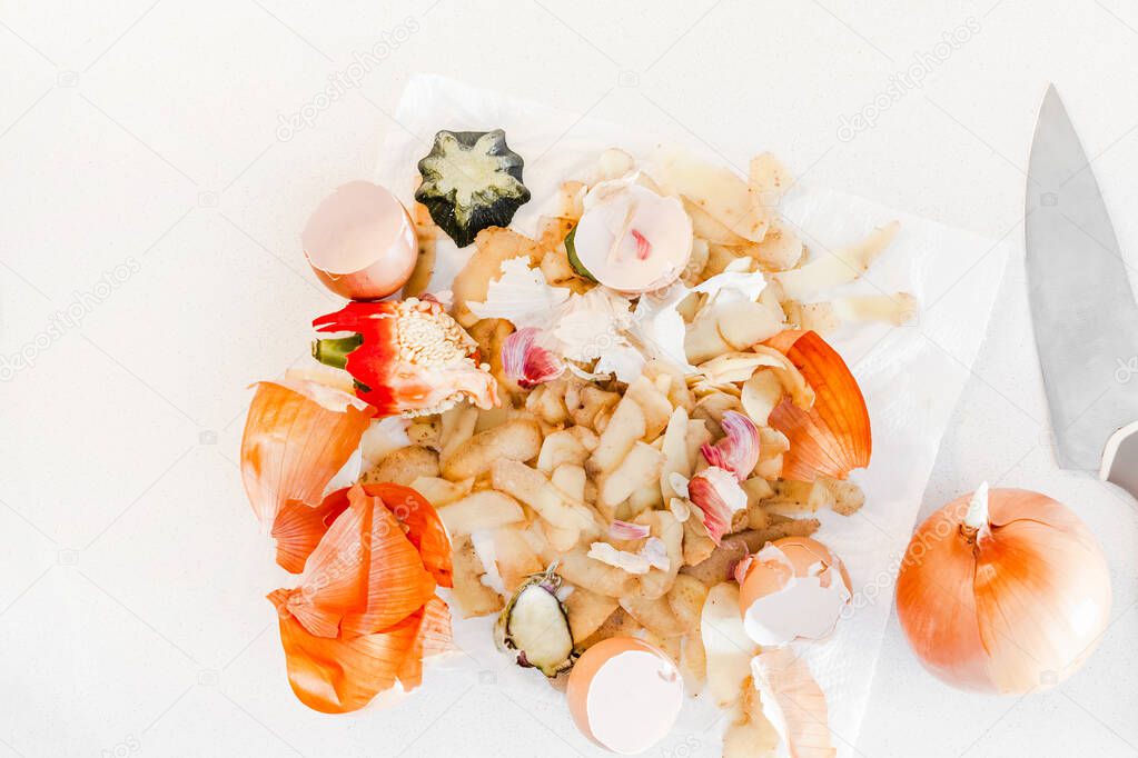 Organic home cooking food waste ready to compost. Ecological concept. Vegetable Peelings on kitchen table. Environmentally responsible behavior, waste management, recycling garbage. Top view