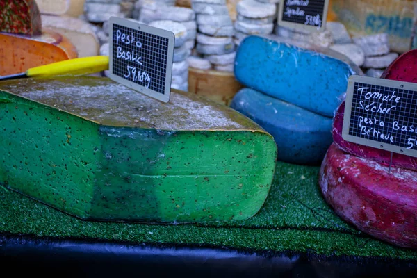 French cheese of different colors, - blue, pink, green,  on french market — Stock Photo, Image