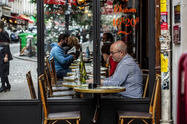 Parisians and tourists enjoy food and drinks in cafe sidewalk in Paris — Stock Photo, Image