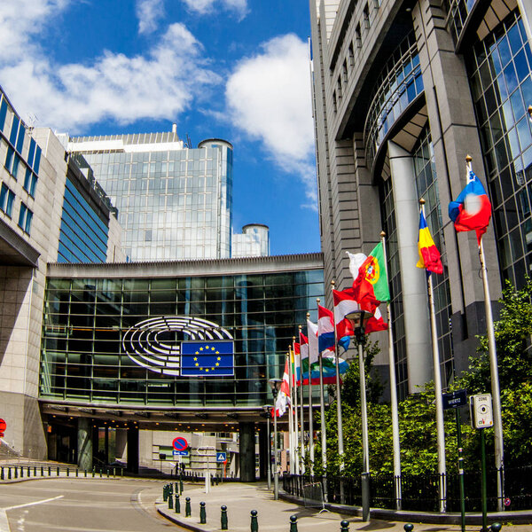 BRUSSELS, BELGIUM - MAY 20, 2015: European Parliament offices and European flags.