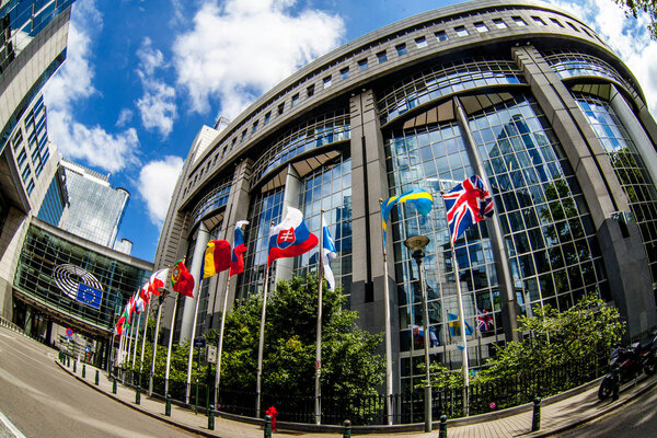 BRUSSELS, BELGIUM - MAY 20, 2015: European Parliament offices and European flags.