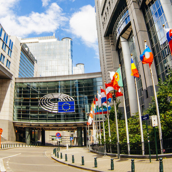 BRUSSELS, BELGIUM - MAY 20, 2015: European Parliament offices and European flags.