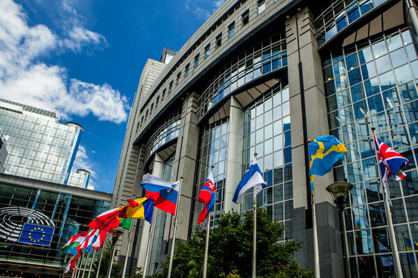 BRUSSELS, BELGIUM - MAY 20, 2015: European Parliament offices and European flags.