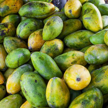 Sweet tasty mango in market - fruit background clipart