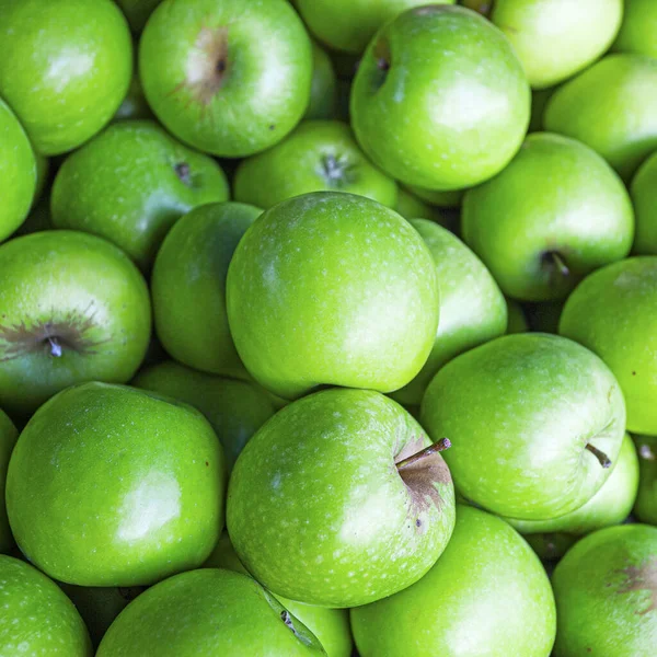 Fresh fruits vitamins background - bright green apples in market