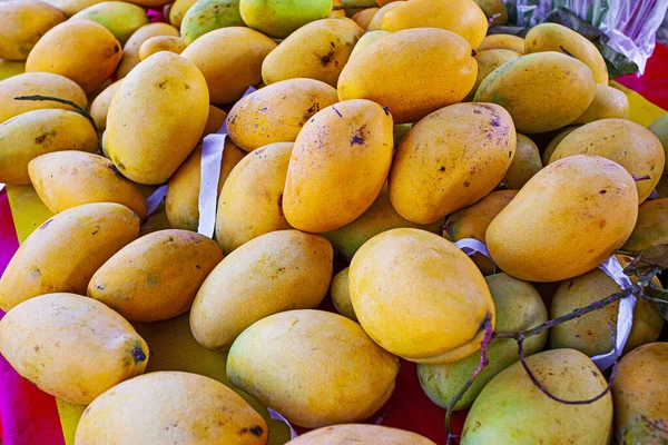 Sweet tasty mango in market - fruit background