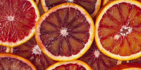 Red sicilian orange slices background