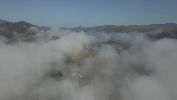 Survoler le brouillard et les nuages dans les montagnes des Carpates près du village de Dzembronya, en Ukraine 