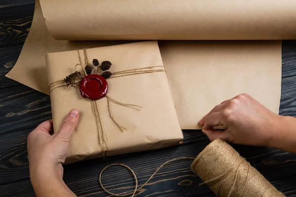 Process of package gift wrapped in craft paper, tied with string