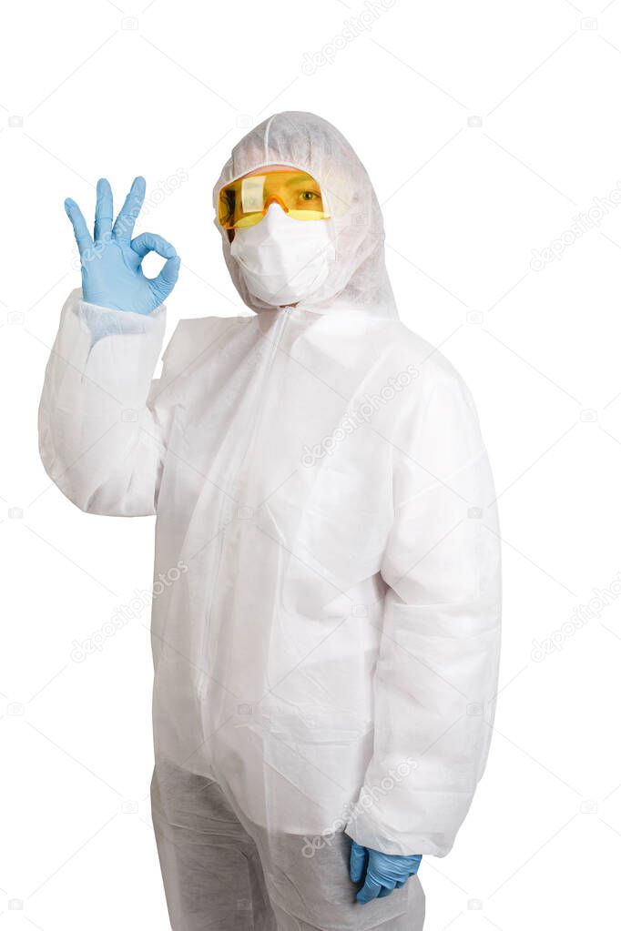 Doctor in disposable anti-epidemic suit wearing a mask and glasses making ok symbol isolated on white background