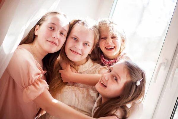 Vier Zussen Zitten Aan Het Raam Knuffelen — Stockfoto