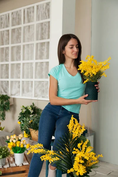 young woman with  bouquet of mimosa