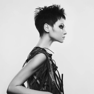 Güzel, genç ve güzel bir bayan. Şık kuaförlü klasik bir kadın portresi. Fotoğrafçılık stüdyosunda gri arka planda siyah saçlı seksi beyaz bir model.