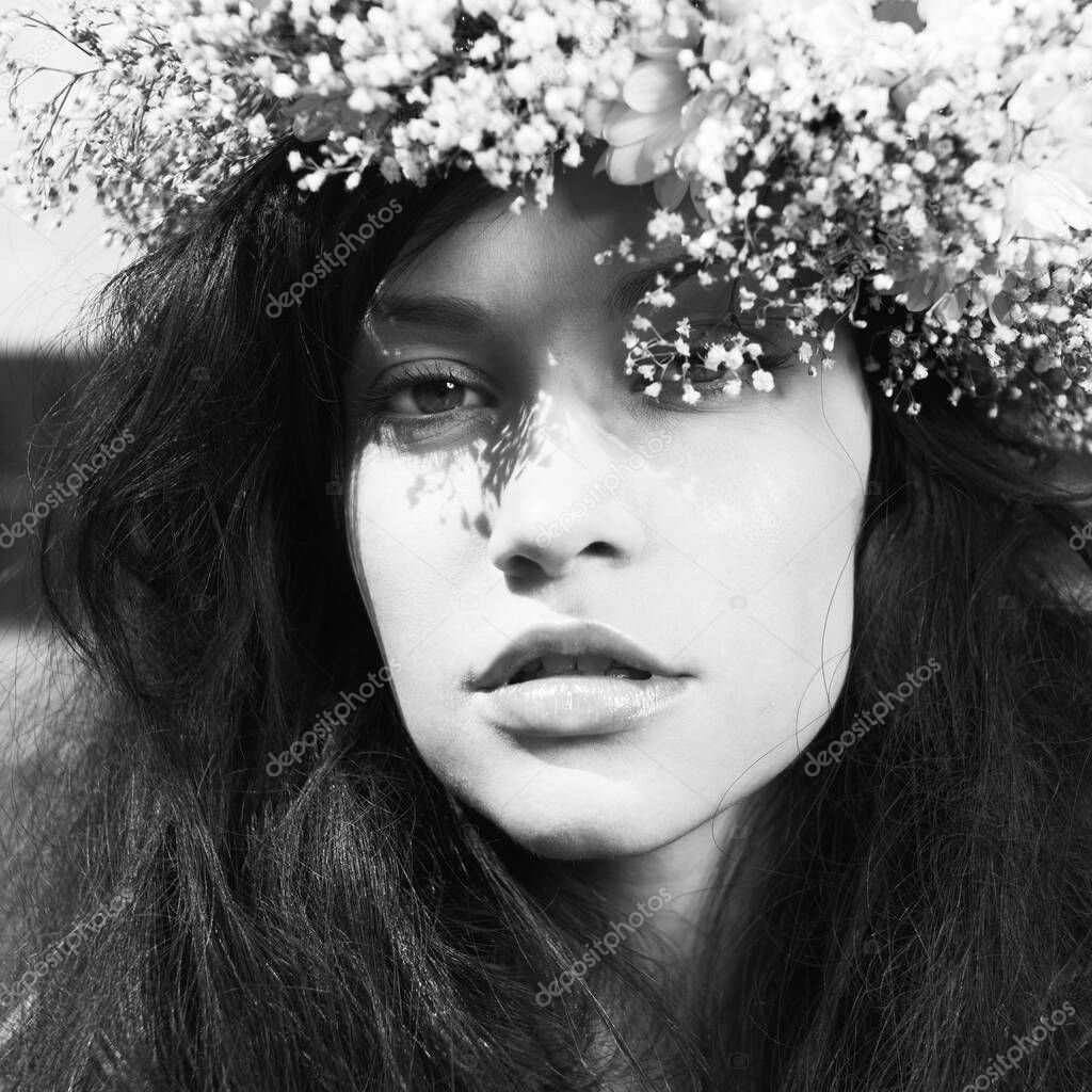 Fashion portrait beautiful girl wearing a wreath of wildflowers