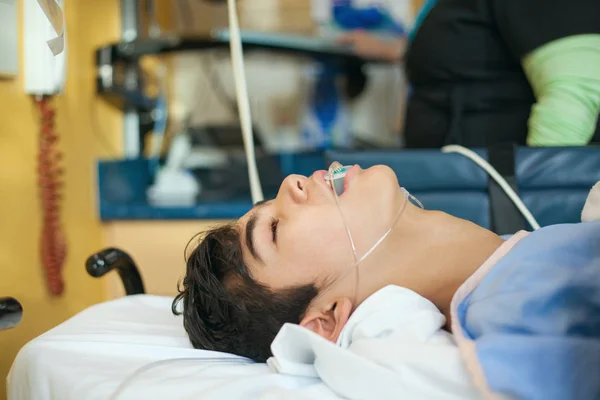 Jong tiener jongen bewusteloos in ziekenhuis herstel kamer op brancard — Stockfoto