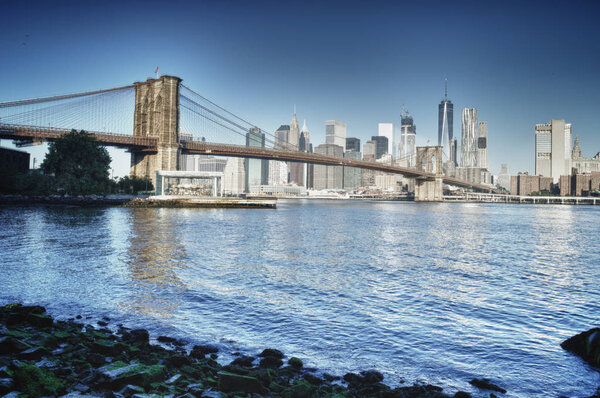 HDR view of Manhattan skyline with Brooklyn Bridge.