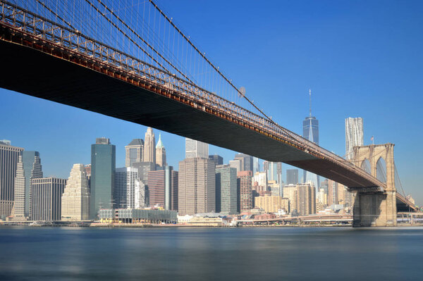Manhattan skyline with Brooklyn Bridge - long exposure image.