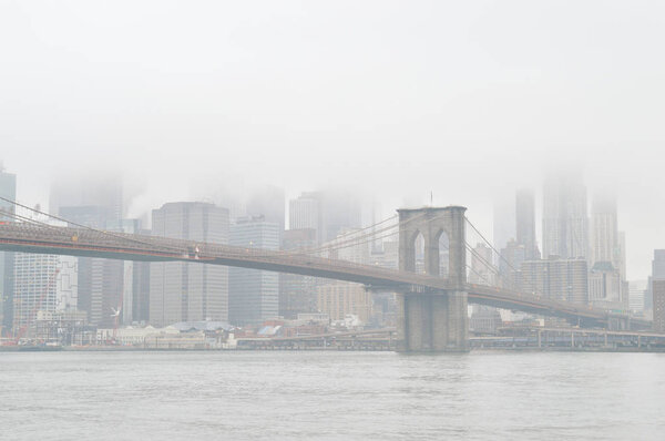 Brooklyn Bridge at foggy day - view from Brooklyn.