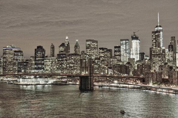 HDR view of Lower Manhattan with Brooklyn Bridge at night.