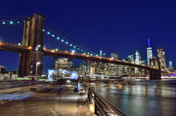 Brooklyn Bridge at night taken from Brooklyn Bridge Park .