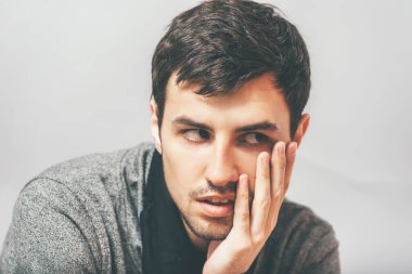 Adam yorgun ve eli çenesinde.