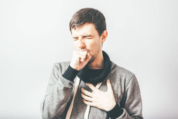 man coughs in photo studio background