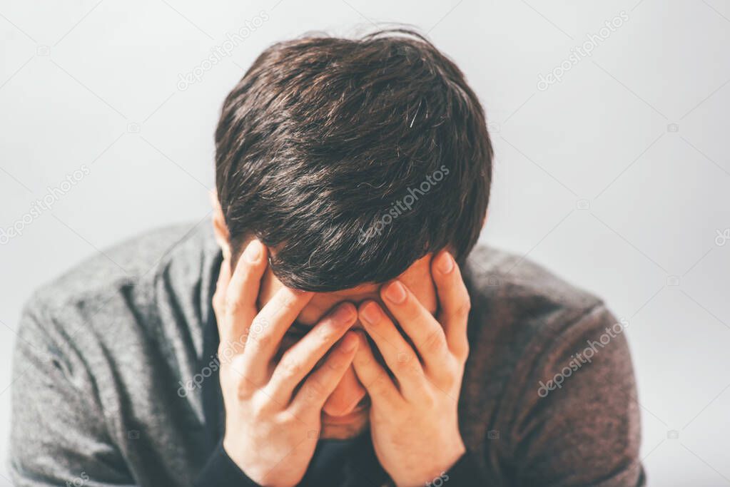 man in despair in photo studio background