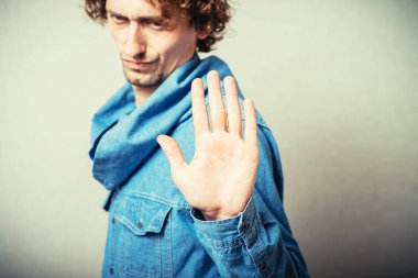 Gri arkaplanda durma gösteren adam