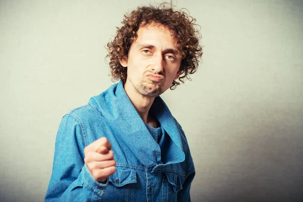 Curly man posing on beige background