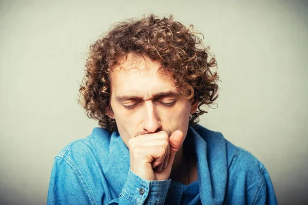 Curly Young Man Coughs Hand Mouth Gray Background — Stock Photo, Image