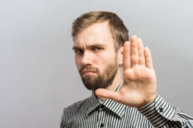 Genç bir adam elleriyle durduruyor. 