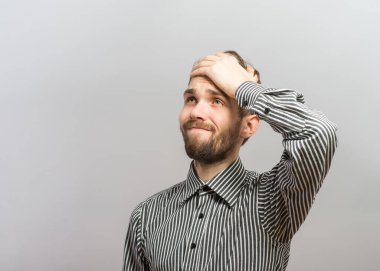 Closeup portrait, goofy, silly young man, slapping hand on head . Negative human emotion facial expression feelings, body language clipart