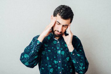 Başı ağrıyan ve kötü hisseden adam, parmaklarına odaklan.