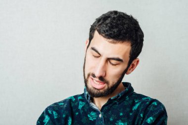 Genç adam şaka yaparken dilini gösteriyor.