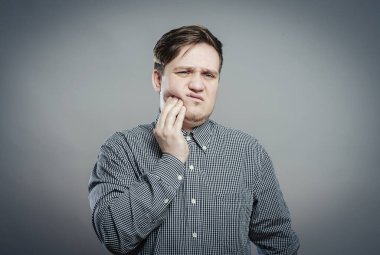 Genç bir adam diş ağrısı hisseder.