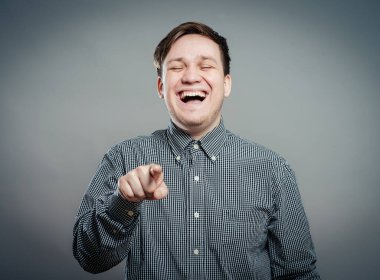 Akıllı genç adam gülümseyip seni işaret ediyor.