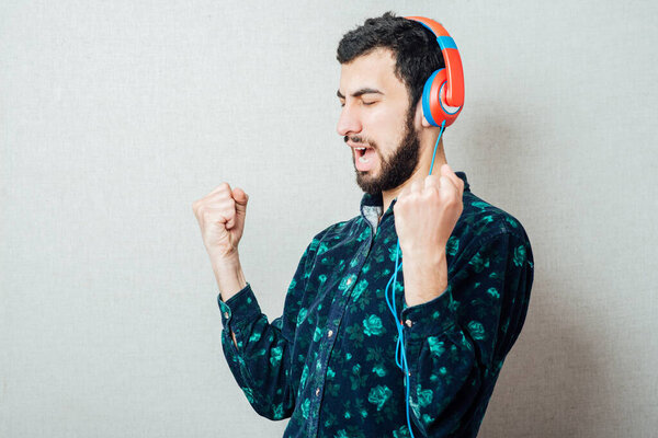 man listens music with headphones